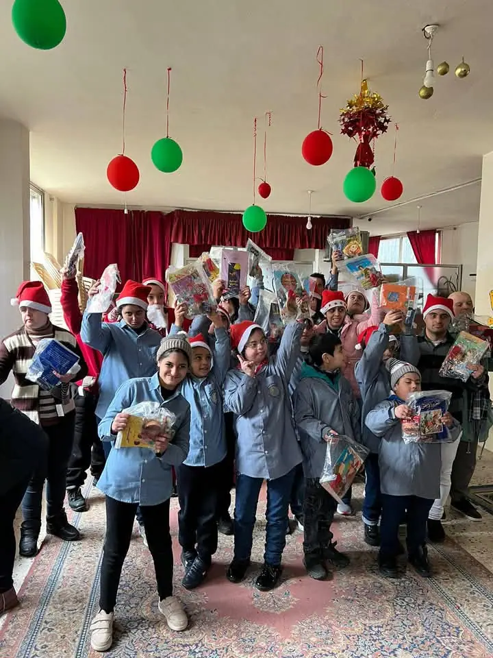 In celebration of the Christmas and New Year holidays, the **Lebanese Association for Sustainability and Social Responsibility (LASSR)** presented a collection of clothing, comic books, and sweets to children with special needs at the Rubu’una Social Charitable Association in Aaley. This initiative falls within the association's efforts to spread joy and foster values of solidarity and social responsibility, particularly during the holiday season.